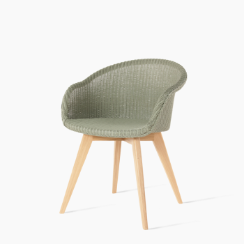 Vincent Sheppard Avril dining chair in sage green with a woven seat and an oak base