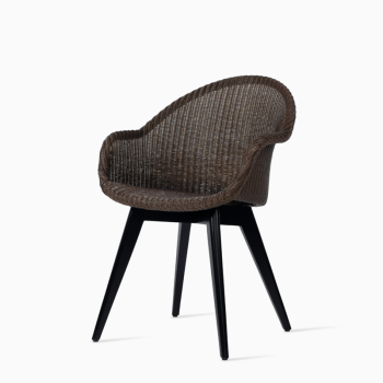 Vincent Sheppard Avril HB dining chair with a brown woven backrest and a black wooden base