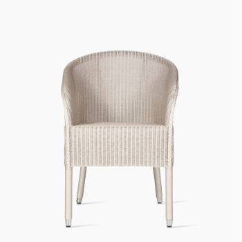 Vincent Sheppard Chester dining chair with a light beige woven design and matching legs