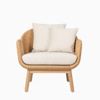 Vincent Sheppard Alex lounge chair with an oak wood base, woven frame, and beige cushions