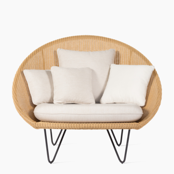 Vincent Sheppard Joe lounge chair in white wash finish with a woven frame, black metal legs, and beige cushions