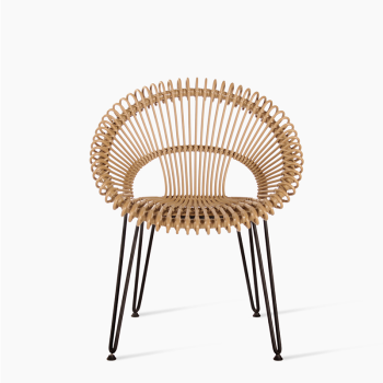 Vincent Sheppard Roxy dining chair in natural rattan with an open-weave circular backrest and slender metal legs