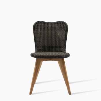 Vincent Sheppard Lena dining chair in mocca with a curved wicker seat and teak wooden legs.