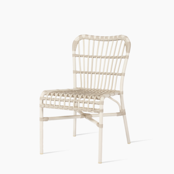 Vincent Sheppard Lucy dining chair in off white with a woven rattan design and sleek metal frame.