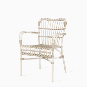 Vincent Sheppard Lucy dining armchair in off white with a woven rattan design, sleek metal frame, and curved armrests.