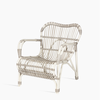 Vincent Sheppard Lucy lazy armchair in off white with a woven rattan design and sleek metal frame.