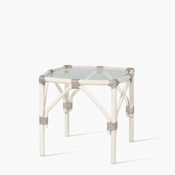 Vincent Sheppard Lucy side table in off white with a woven rattan frame and a square glass top.