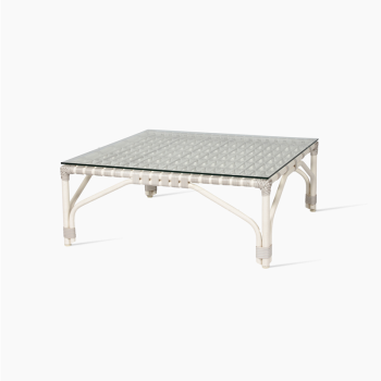 incent Sheppard Lucy coffee table in off white with a woven rattan frame and a square glass top.