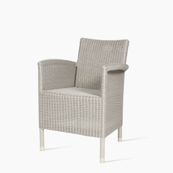 Vincent Sheppard Safi dining chair in old lace with a woven rattan design and armrests.