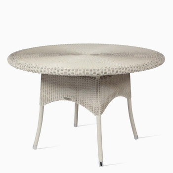  Sheppard Safi dining table with a 120 cm diameter in old lace featuring a woven rattan design and rounded edges.