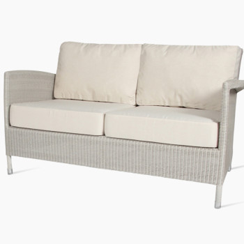 Vincent Sheppard Safi two-seater lounge sofa in old lace with a woven rattan design, featuring cushioned seat and backrest for added comfort.