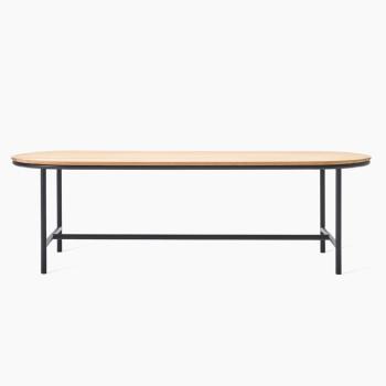 Vincent Sheppard Wicked dining table with a natural wooden top and black metal frame, featuring an elongated oval design.