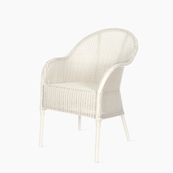 Vincent Sheppard Nice dining chair in white with a woven rattan design, featuring a rounded backrest and slender legs.