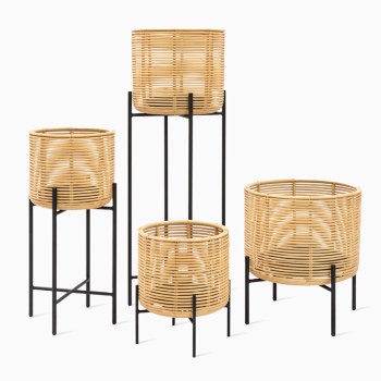 Vincent Sheppard Vivi plant stands in natural rattan with black metal frames, featuring four stands of varying heights.