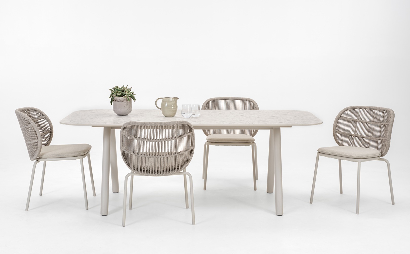 Vincent Sheppard Kodo dining set featuring a dune white dining table with a textured shards surface and matching Kodo dining chairs in dune white with cushions.