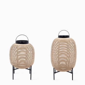 Pair of Vincent Sheppard Tika lanterns in camel colour with black steel bases and handles, featuring a woven design and round shapes in different sizes.