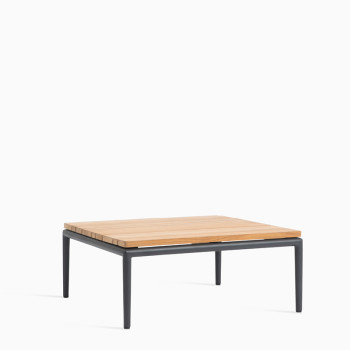 Vincent Sheppard Leo modular coffee table with an untreated teak top and a lava-coloured frame.