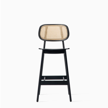 Vincent Sheppard Titus counter stool in black plywood with a woven rattan backrest.