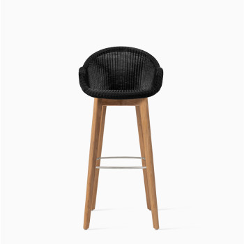 Vincent Sheppard Edgard bar stool with a black woven seat and a teak wood base.