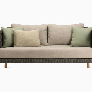 Vincent Sheppard Lento lounge sofa with teak frame and anthracite weave, featuring almond cushions and green decorative cushions.