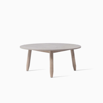 Vincent Sheppard coffee table with a 68 cm diameter round flint-coloured top and aged teak legs.