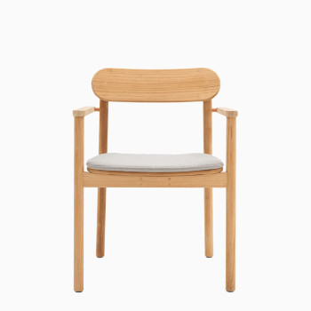 Vincent Sheppard Freya dining armchair made of teak, featuring an almond cushion on the seat.