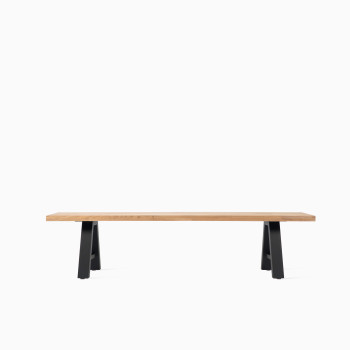 Vincent Sheppard Matteo bench with a light wood seat and black A-frame metal legs