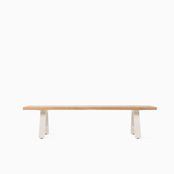 Vincent Sheppard Matteo bench with a light wood seat and white A-frame metal legs