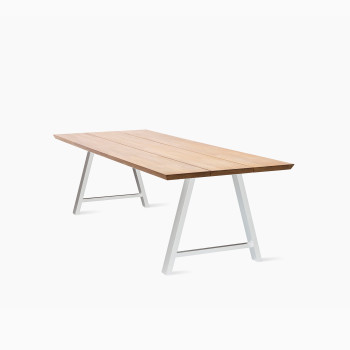 Vincent Sheppard Matteo dining table with a light wood top and white metal legs in an angled A-frame design