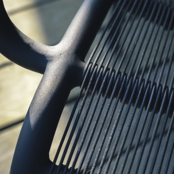 Close-up of the black Vincent Sheppard Loop lounge chair at Cobergher Hotel showing the detailed woven design.