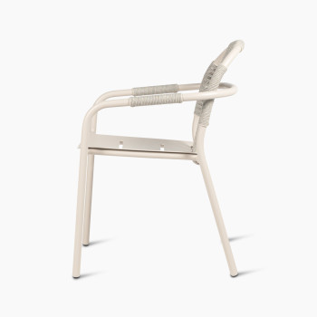 ide view of Vincent Sheppard Cleo dining armchair in dune white, featuring a woven backrest and aluminium frame.