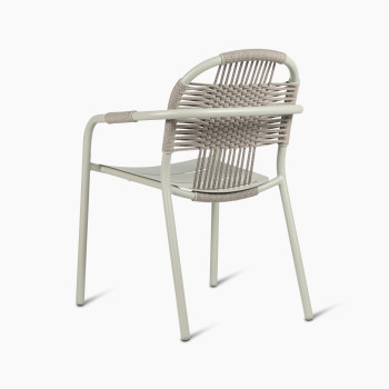 Back view of Vincent Sheppard Cleo dining armchair in sage green with a woven backrest and aluminium frame.