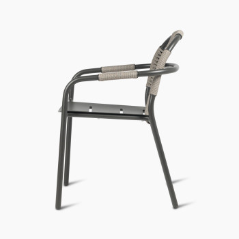 Side view of Vincent Sheppard Cleo dining armchair in fossil grey, featuring a woven backrest and aluminium frame.