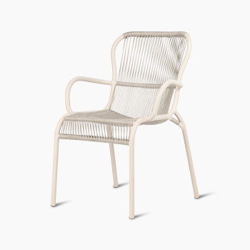 45-degree view of the Loop dining chair by Vincent Sheppard in Dune white, featuring a woven seat and backrest with curved, minimalist armrests.