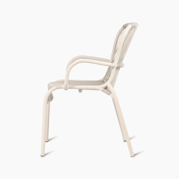 Side view of the Loop dining chair by Vincent Sheppard in Dune white, showcasing the curved armrests and woven seat and backrest.