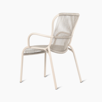 135-degree view of the Loop dining chair by Vincent Sheppard in Dune white, highlighting the woven backrest, seat, and smooth, curved armrests.