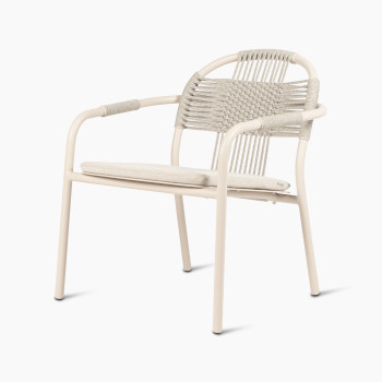 Vincent Sheppard Cleo lounge chair in dune white with an almond-coloured seat cushion, featuring a woven rope backrest and armrests