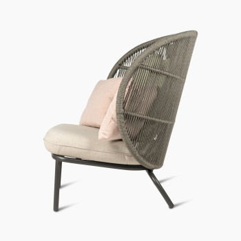 Side view of the Kodo Cocoon in fossil grey with almond seat and decorative cushions in blush and olive green by Vincent Sheppard.