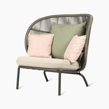 Kodo Cocoon in fossil grey with almond seat and decorative cushions in olive green and blush by Vincent Sheppard, 45-degree view.