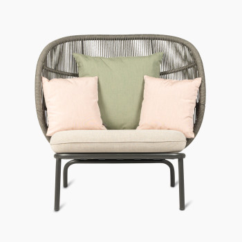 Kodo Cocoon in fossil grey with almond seat and decorative cushions in olive green and blush by Vincent Sheppard, front view.