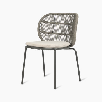 Vincent Sheppard Kodo dining chair with a fossil grey frame and almond cushion, shown at a 45-degree angle.