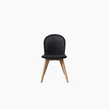 Yann chair by Vincent Sheppard with a black woven seat and backrest, set on a natural oak base