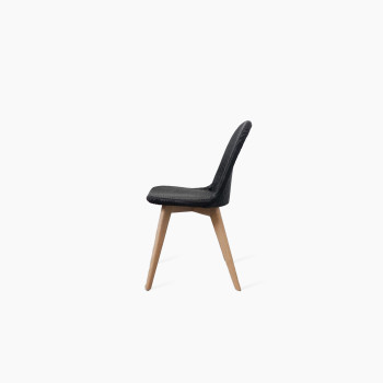  Side view of the Vincent Sheppard Yann chair with an oak base and black upholstered seat