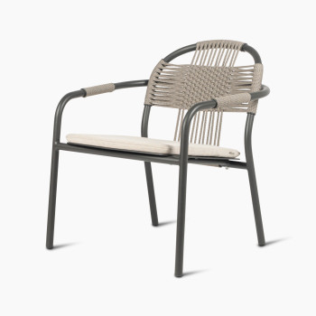 Vincent Sheppard Cleo lounge chair in fossil grey with an almond-coloured seat cushion and a woven backrest, angled view