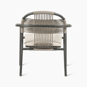 Back view of the Vincent Sheppard Cleo lounge chair in fossil grey with an almond-coloured seat cushion and woven backrest