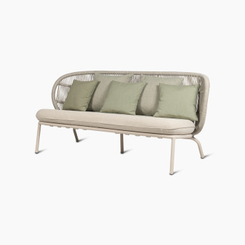 45-degree view of the Kodo lounge sofa in Dune white with almond seat cushion and decorative cushions in olive green and blush by Vincent Sheppard.