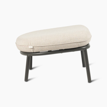 Side view of the Kodo footrest in fossil grey with almond cushion by Vincent Sheppard.