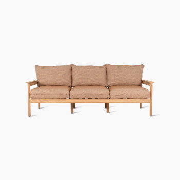 Vooraanzicht van de Vincent Sheppard Oda 3-zits loungesofa met licht houten frame en kussens van Sienna-stof.