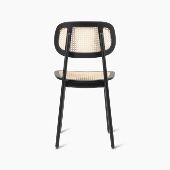 Back view of a Titus dining chair in black stained oak with a woven cane backrest and seat.