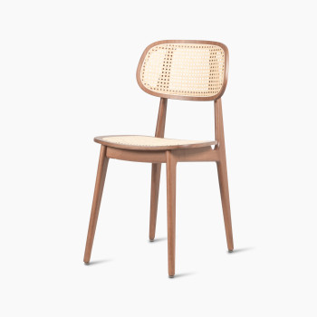 45-degree view of a Titus dining chair in tobacco stained beech with a woven cane backrest and seat.